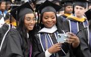 Students pose for a selfie during the undergraduate Commencement exercise Saturday, 5月4日, 2024.